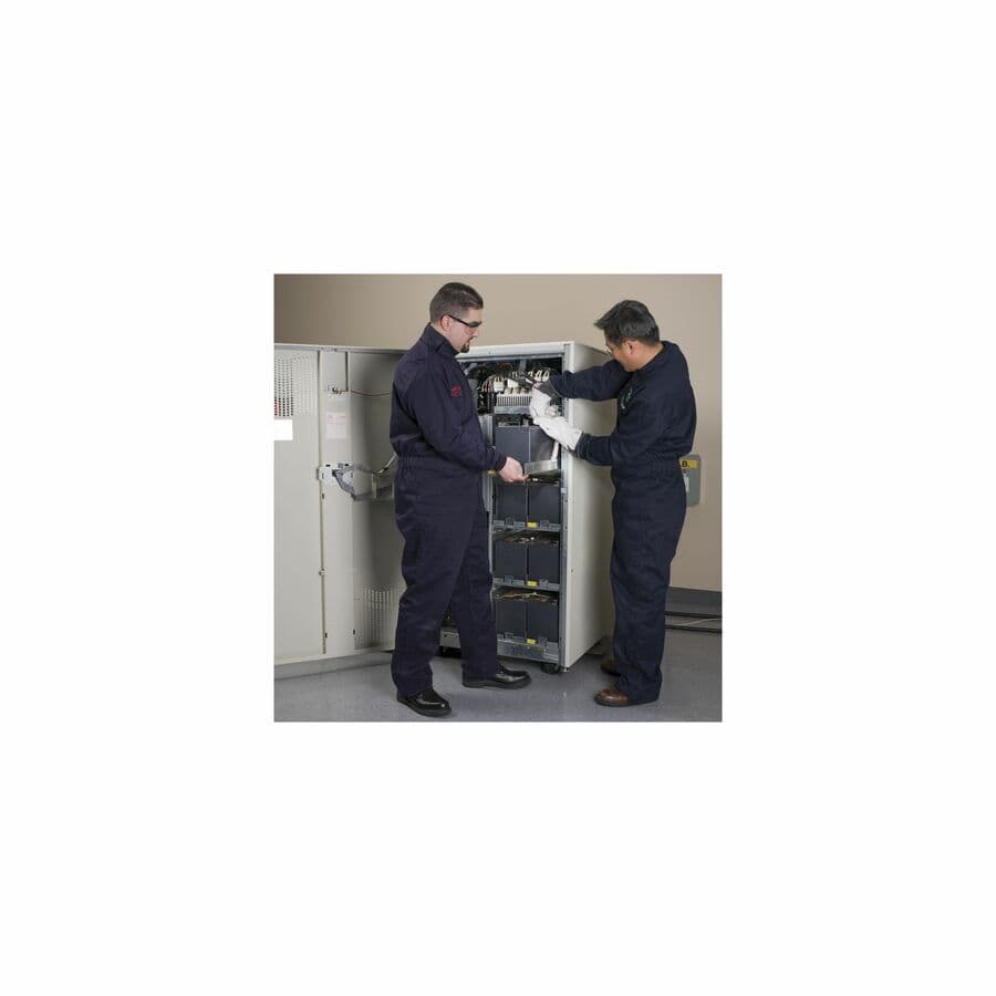 APC technician installing a Batt Manager main system module and fitting a tab washer inside a rack enclosure